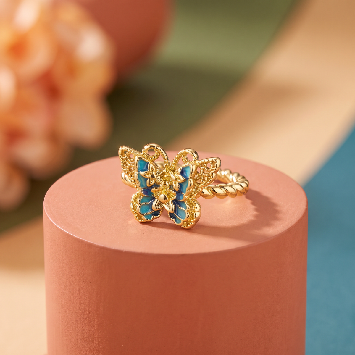 Blue enamel butterfly on a twisted rope band, antique gold-toned adjustable ring